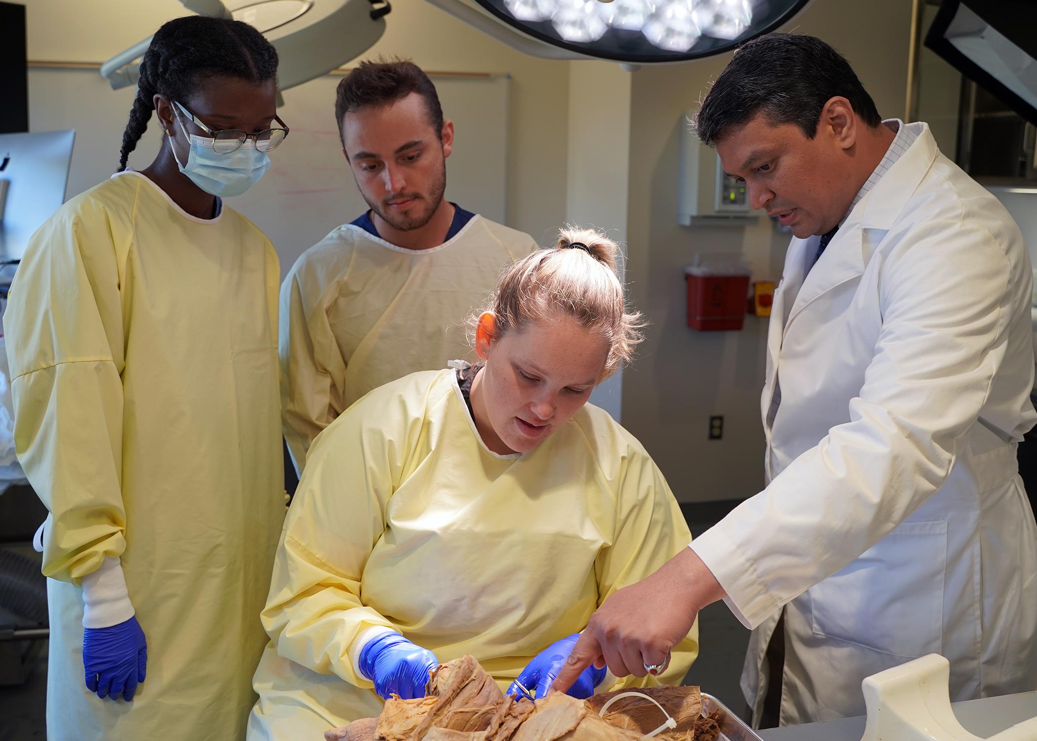 A group of students and faculty in an anatomy lab