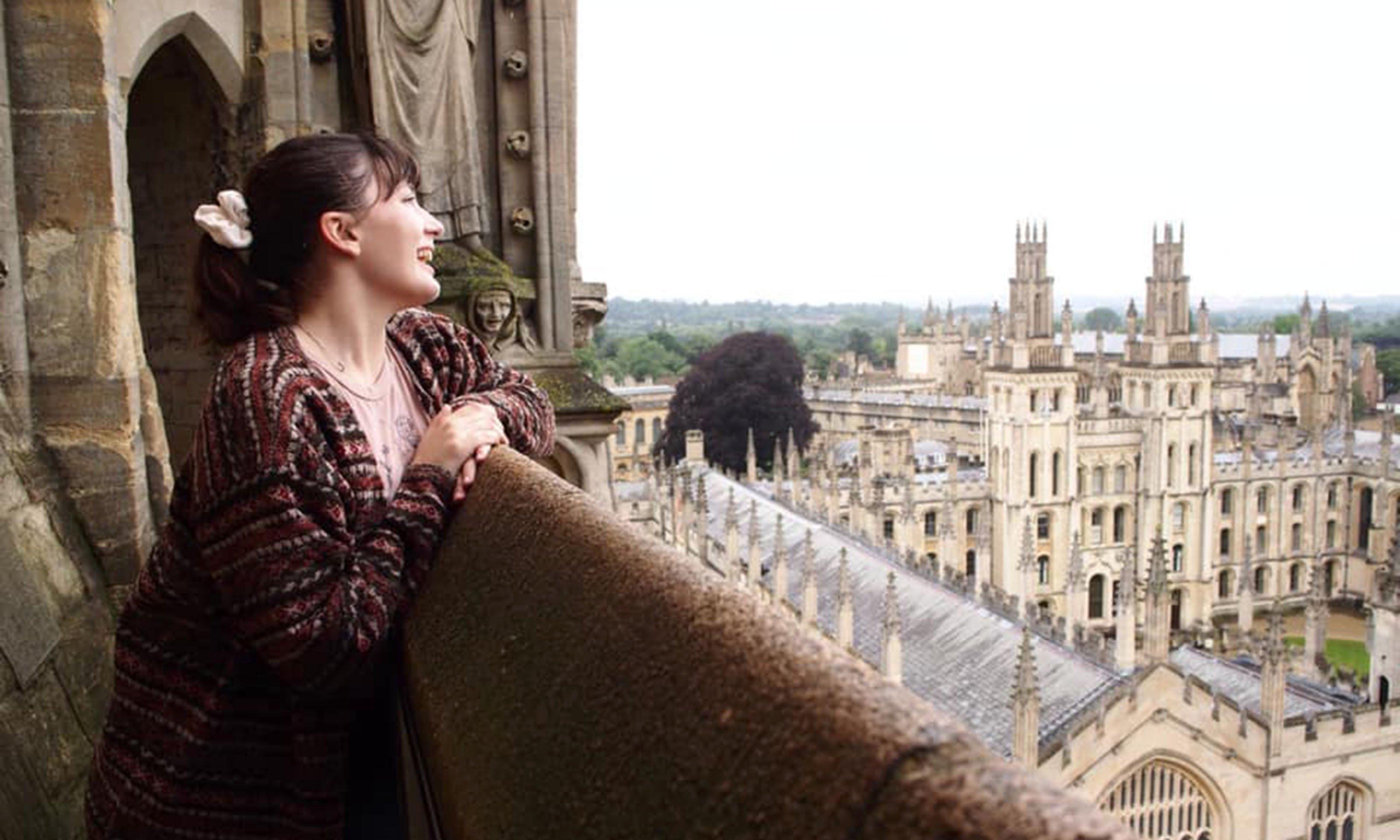 female student looking out over town in Great Britain